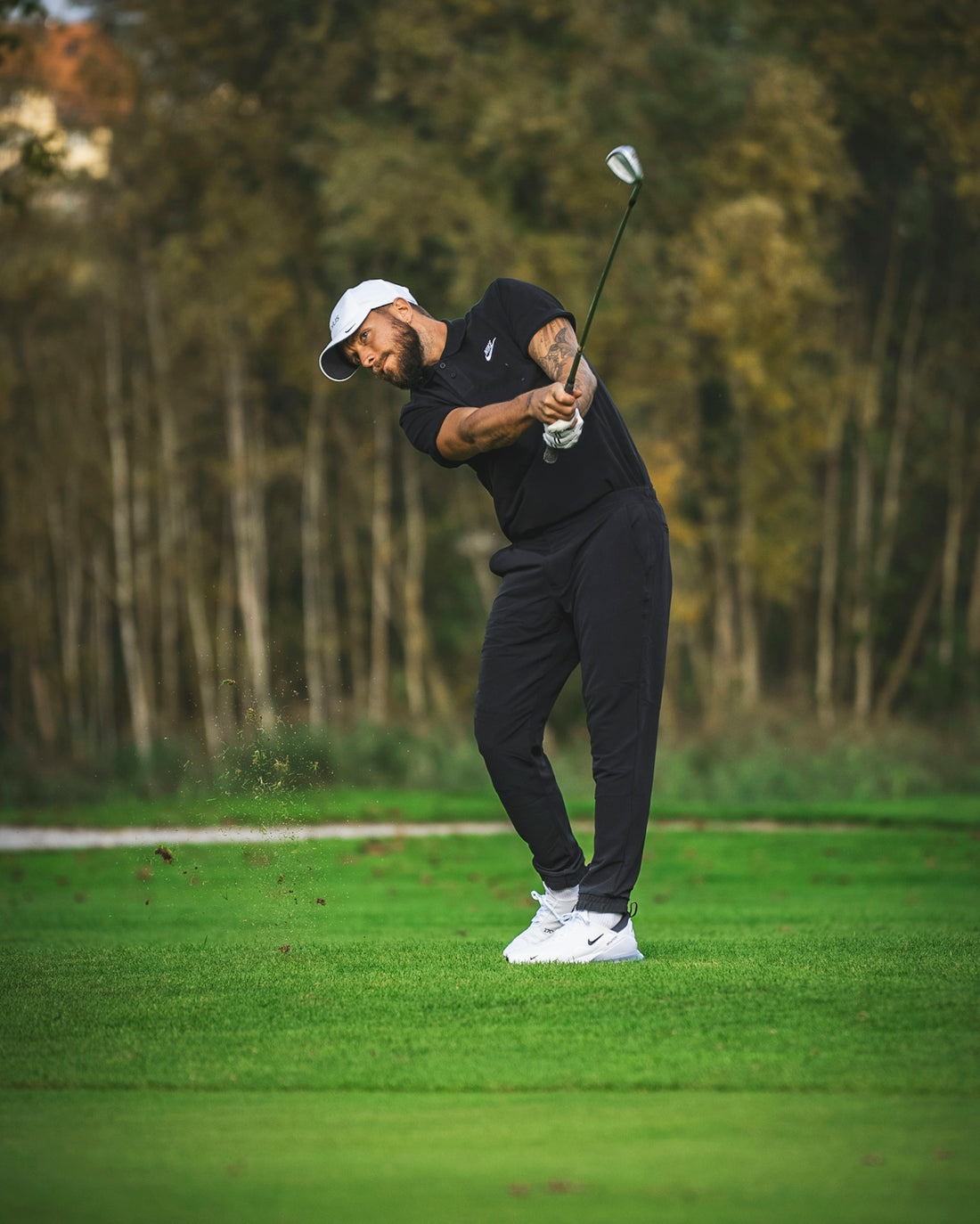 a man hitting a golf ball with a golf club