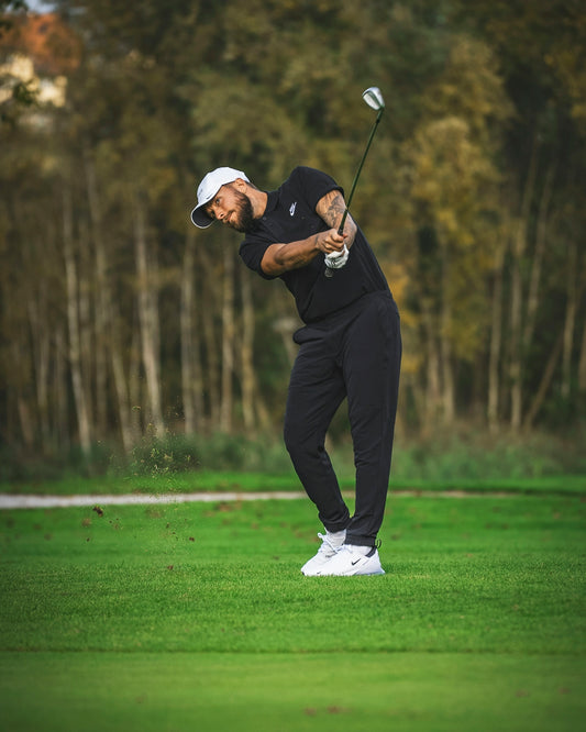 a man hitting a golf ball with a golf club