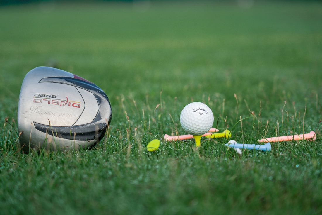 a golf club and a golf ball on the grass