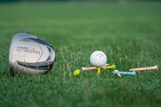 a golf club and a golf ball on the grass