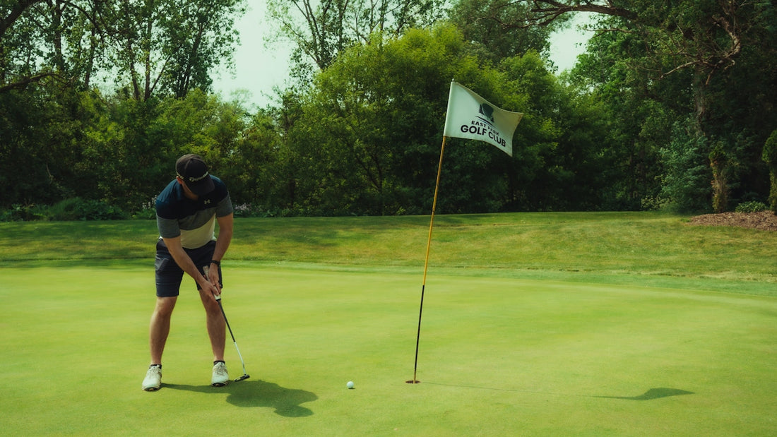 A golfer is putting the golf ball